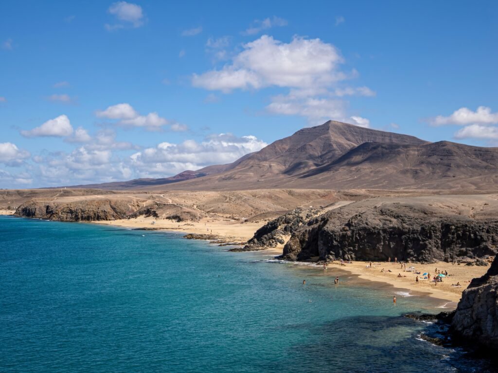 Idyllic coastline with mountains and beach in summer, perfect for vacation and relaxation.