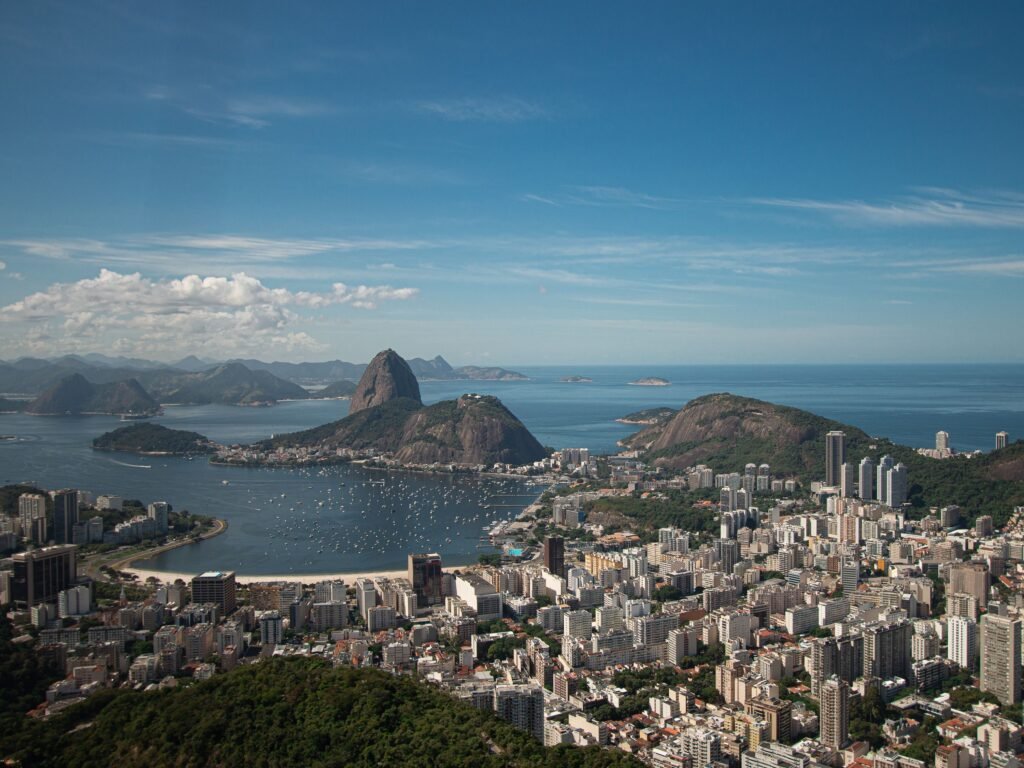 Stunning aerial shot of Rio de Janeiro showcasing Sugarloaf Mountain and vibrant cityscape by the Atlantic Ocean.